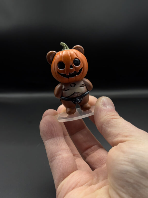 spooky-pumpkin-main Pumpkin bear figurine held in hand